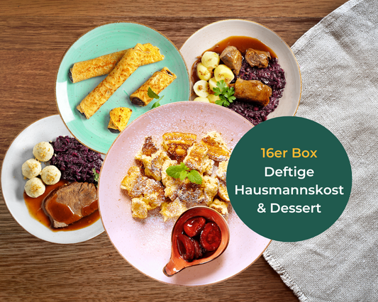 Hausmannskost-Box + Dessert-Box von Hofmanns auf einem Holztisch mit grünem beschreibenden Etikett.